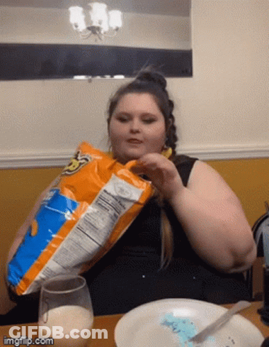 Woman Eating Doritos At Table GIF
