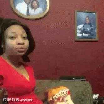 Woman Eating Doritos On Couch GIF