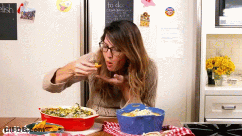 Woman Eating Food In Front Of Chalkboard Saying To Do GIF