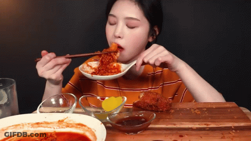 Woman Eating Food With Chopsticks And Sauce GIF