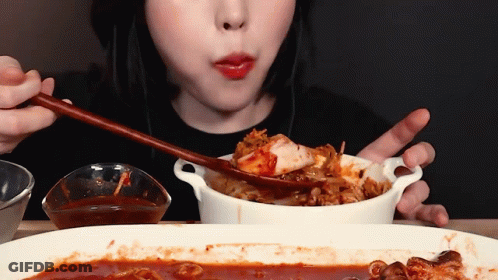 Woman Eating Food With Chopsticks And Spoon GIF