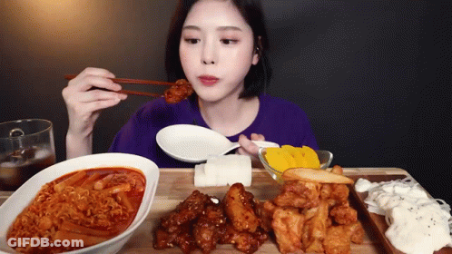 Woman Eating Food With Chopsticks GIF