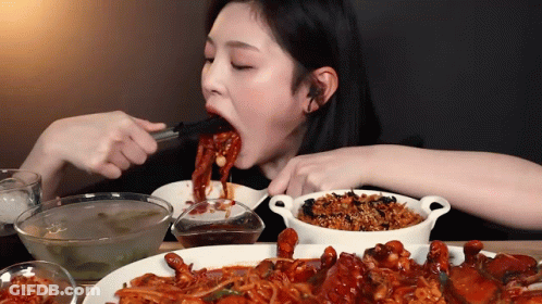 Woman Eating Food With Chopsticks GIF