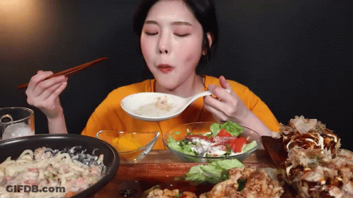 Woman Eating Food With Chopsticks GIF