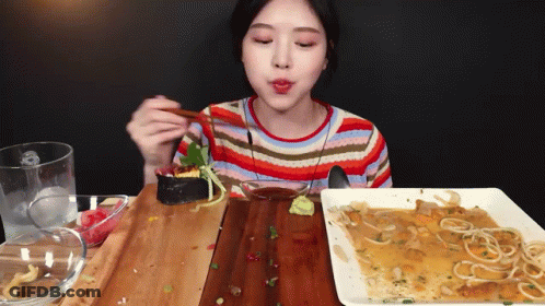 Woman Eating Food With Chopsticks GIF