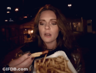 Woman Eating French Fries At Night With Open Mouth GIF