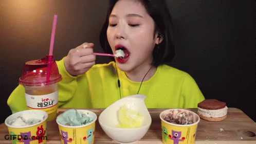 Woman Eating Ice Cream From Cup With Straw GIF
