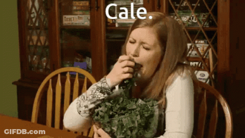 Woman Eating Kale In Front Of Bookcase GIF