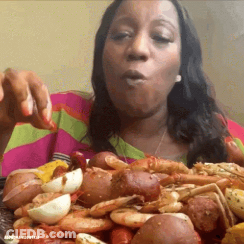 Woman Eating Lots Of Food From Mardi Gras Don Tia Plate GIF