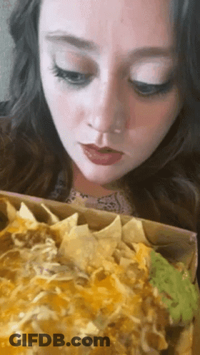 Woman Eating Nachos With Guacamole GIF