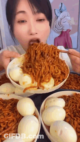 Woman Eating Noodles And Eggs From Bowl GIF