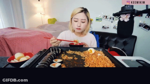 Woman Eating Noodles And Sushi GIF