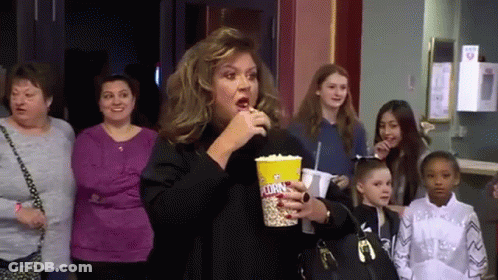 Woman Eating Popcorn In Theater GIF