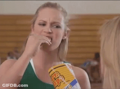 Woman Eating Popcorn While Another Looks On GIF