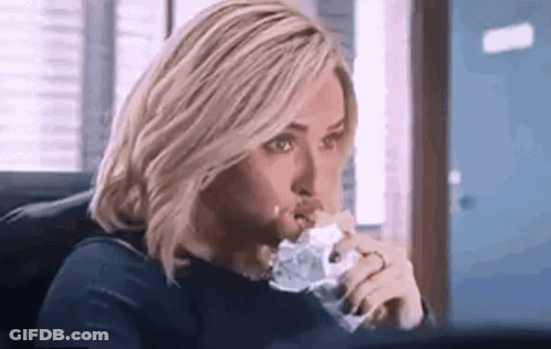 Woman Eating Sandwich At Computer GIF