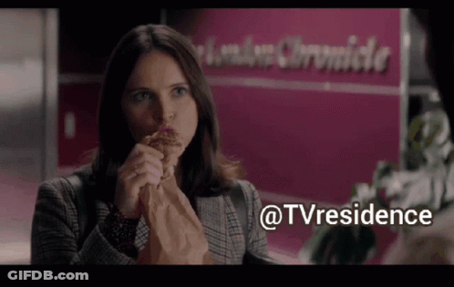 Woman Eating Sandwich In Front Of London Chronicle Sign GIF