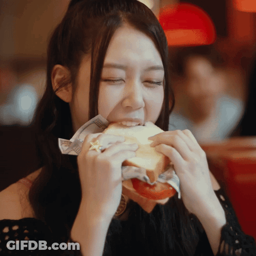 Woman Eating Sandwich With Star On Finger GIF