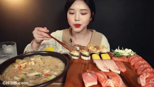 Woman Eating Sushi With Chopsticks GIF