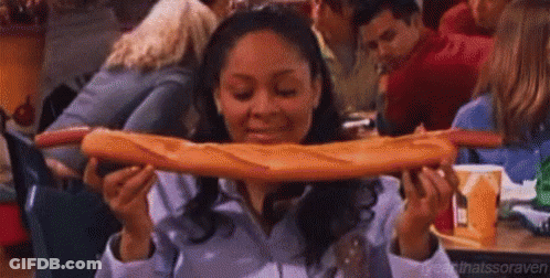 Woman Eating Very Long Loaf Of Bread GIF