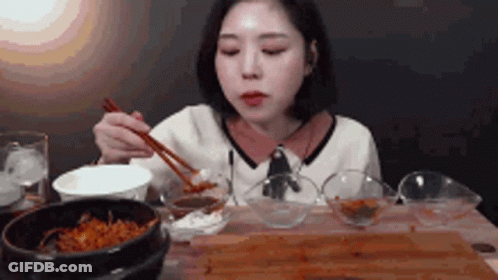 Woman Eating With Chopsticks GIF