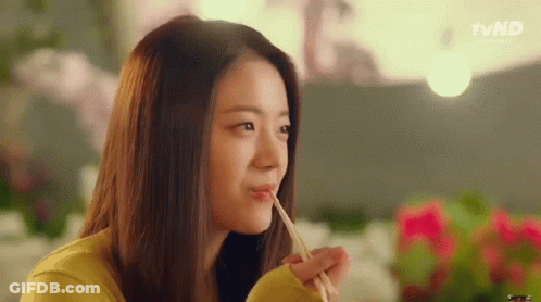 Woman Eating With Chopsticks In Restaurant GIF