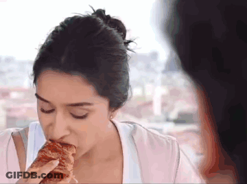 Woman Eating With Eyes Closed GIF