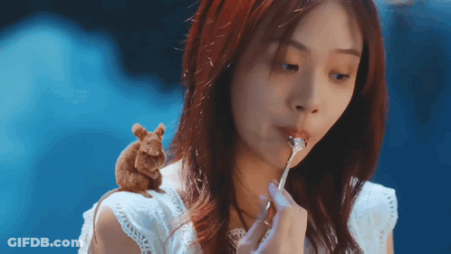 Woman Eating With Mouse On Shoulder GIF