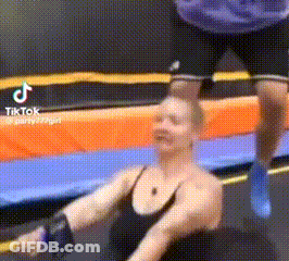 Woman Exercising On Trampoline With Man Behind GIF