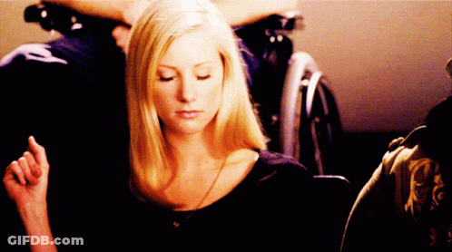 Woman Eyes Closed, Man In Wheelchair Behind GIF