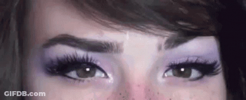 Woman Eyes With Purple Eye Shadow And Long Eyelashes GIF