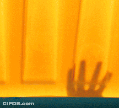 Woman Face Behind Yellow Curtain GIF
