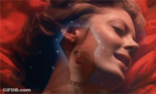 Woman Face Surrounded By Red Flowers GIF