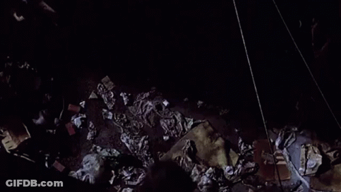 Woman Falling Off Brick Wall At Night GIF