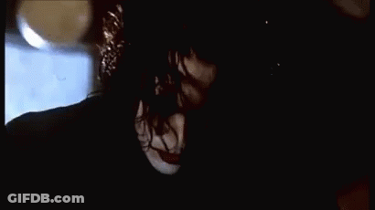 Woman Falling Off Brick Wall At Night GIF