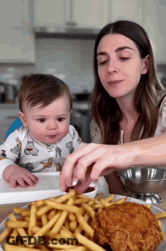 Woman Feeding Baby French Fries And Chicken GIF
