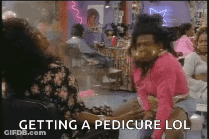 Woman Feet With Red Toenails And Toe Separators GIF