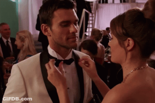 Woman Fixing Man's Bow Tie At Party GIF
