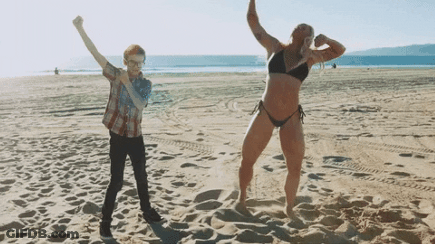 Woman Flexing Muscle Growth On Beach GIF