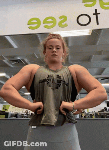 Woman Flexing Muscles At Sign 992 GIF
