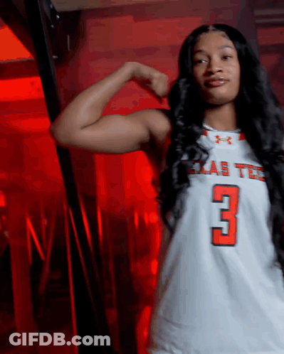 Woman Flexing Muscles In Texas Tech Jersey GIF