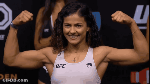 Woman Flexing Muscles In UFC Tank Top GIF