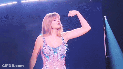 Woman Flexing Muscles On Stage GIF