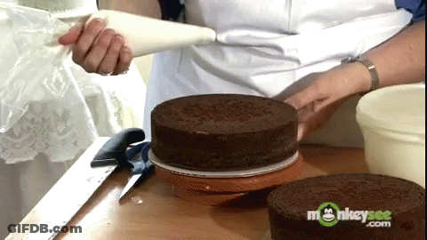 Woman Frosting Chocolate Cake With Monkeysee.com GIF