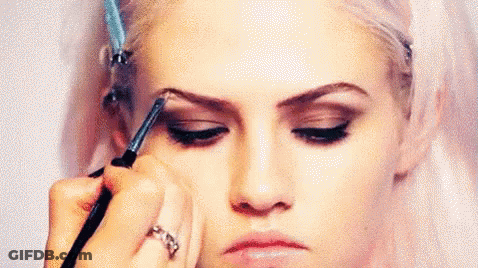 Woman Getting Eyebrows Painted By Makeup Artist GIF