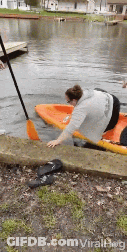 Woman Getting Out Of Kayak In Water GIF