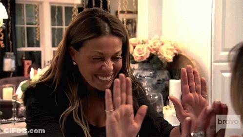 Woman Giving High Five With Bravo Logo GIF