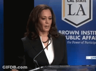 Woman Giving Speech In Front Of Sign Saying La GIF
