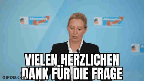 Woman Giving Speech In Front Of Vielen Herzlichen Dank For Die Frage Sign GIF