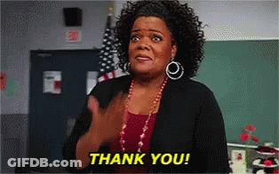 Woman Giving Thank You Gesture In Front Of Chalkboard GIF