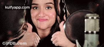 Woman Giving Thumbs Up At Microphone GIF